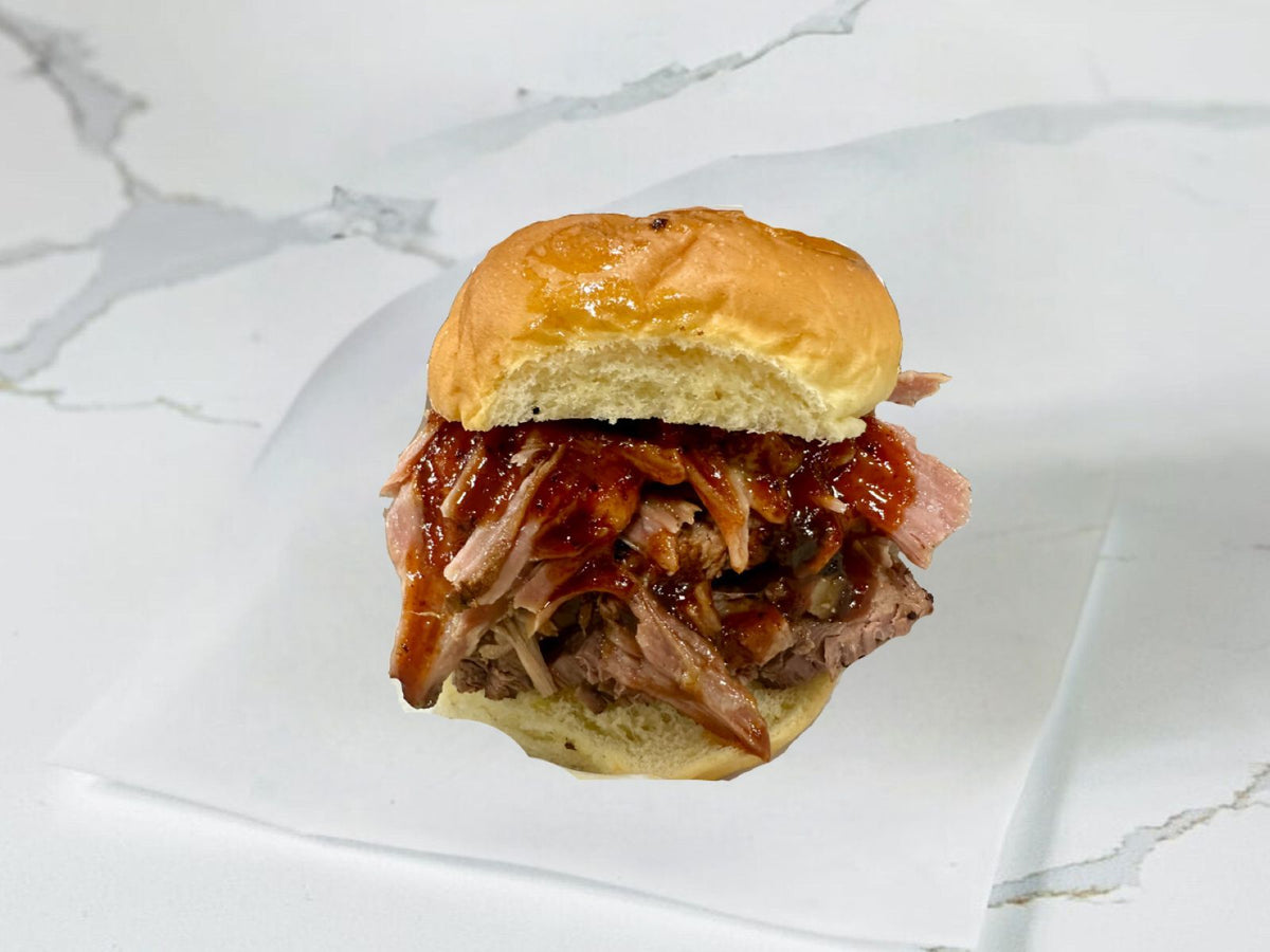 Hair of the Pig sandwich with smoked brisket and pulled pork at Embark Smoked Meats